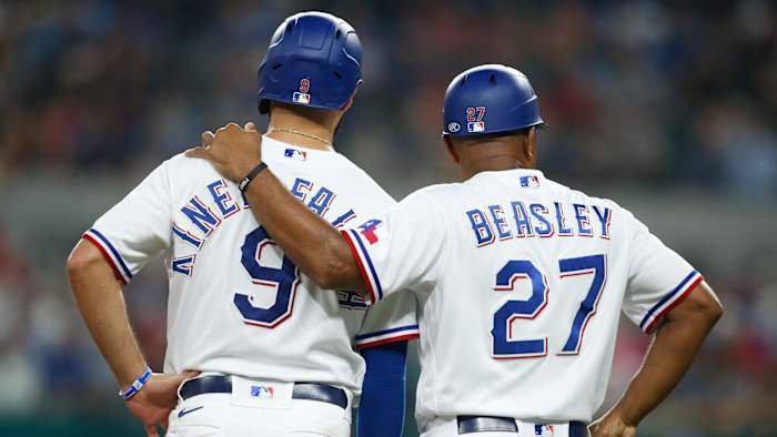 Aug 4, 2021; Arlington, Texas, USA; Texas Rangers third base coach Tony Beasley (27) talks to shortstop Isiah Kiner-Falefa (9) in the sixth inning against the Los Angeles Angels at Globe Life Field.